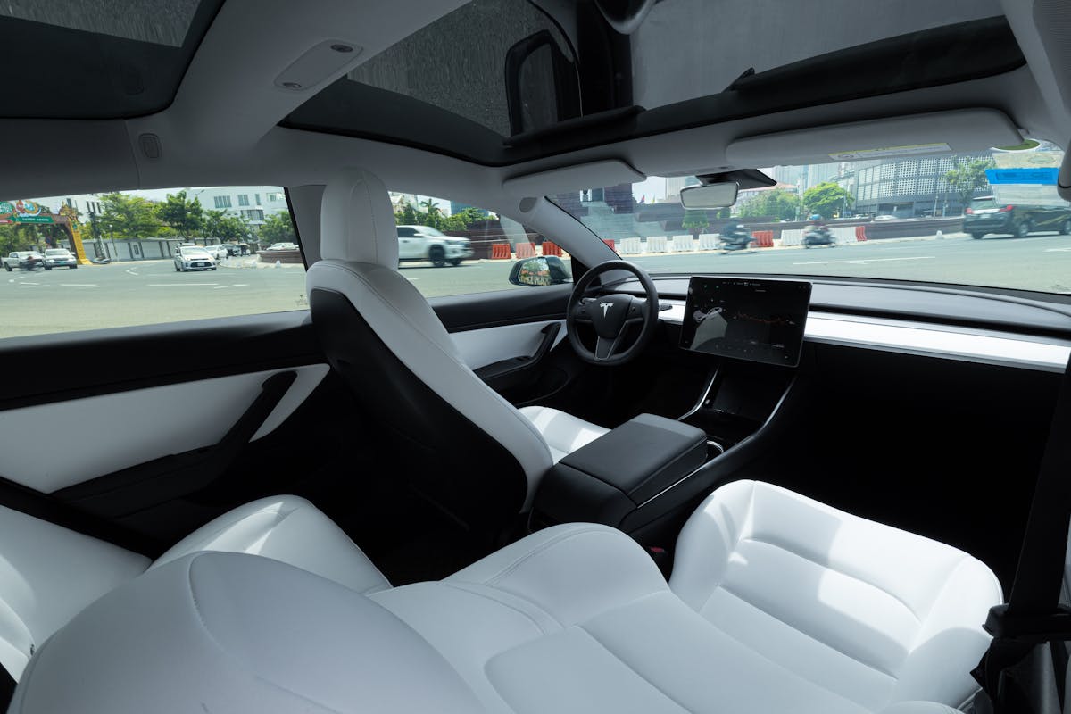Tesla interior showing the panoramic glass roof overhead